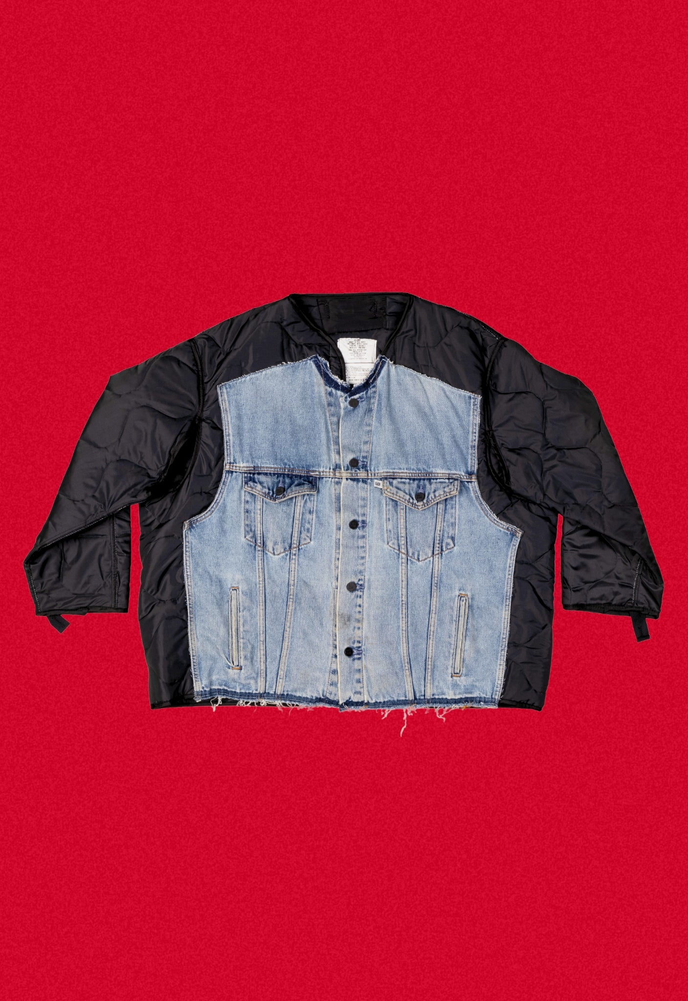 Black quilted repurposed denim jacket on a red background